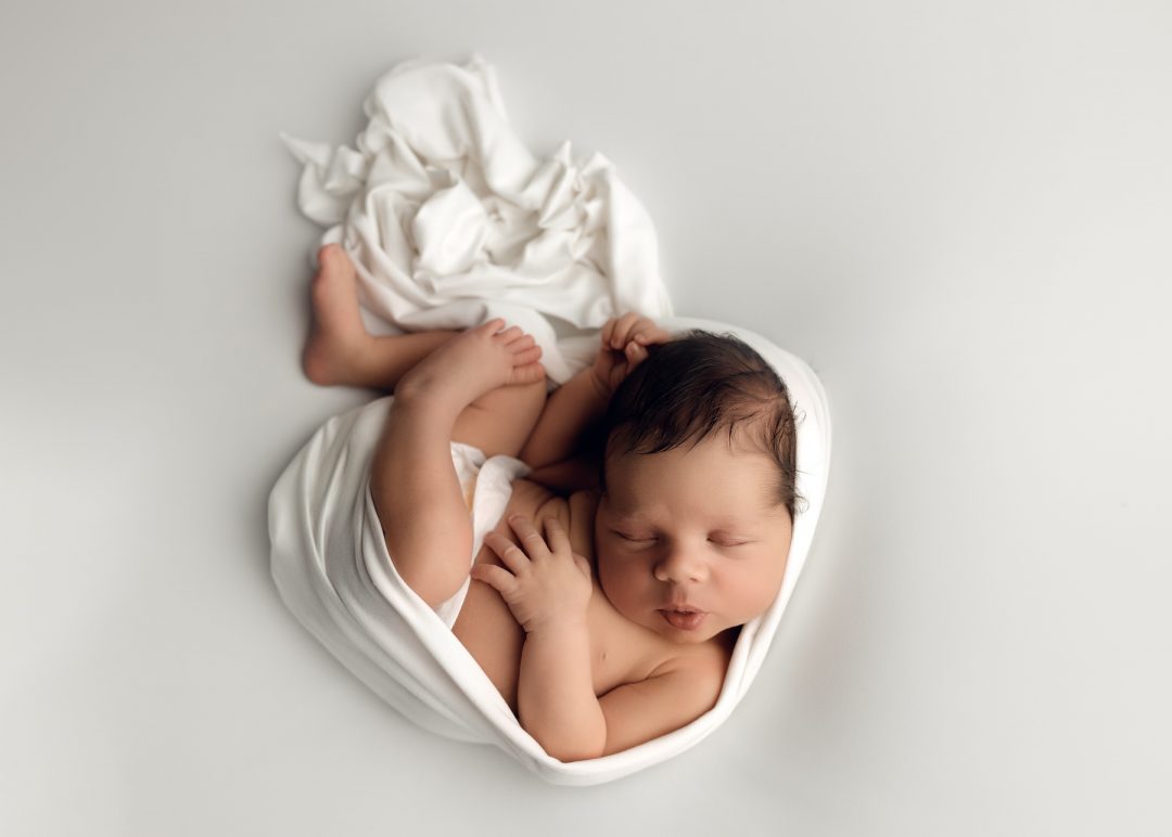 Newborn baby photographed at EvaGud Photography studio in Barking
