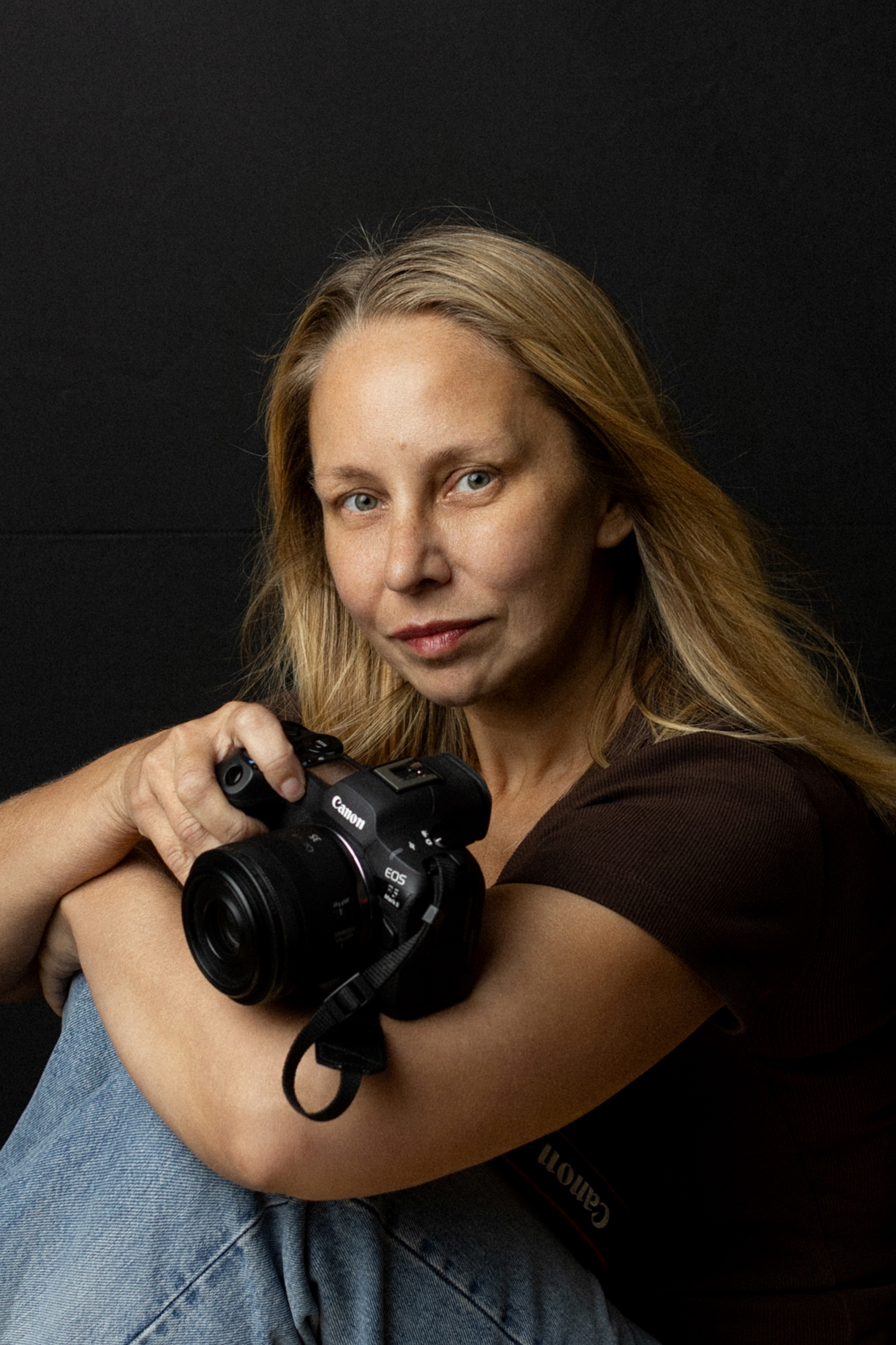 Eva, newborn and family photographer in Barking, holding her camera